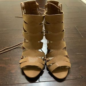 Wedge shoes that tie up the calf.